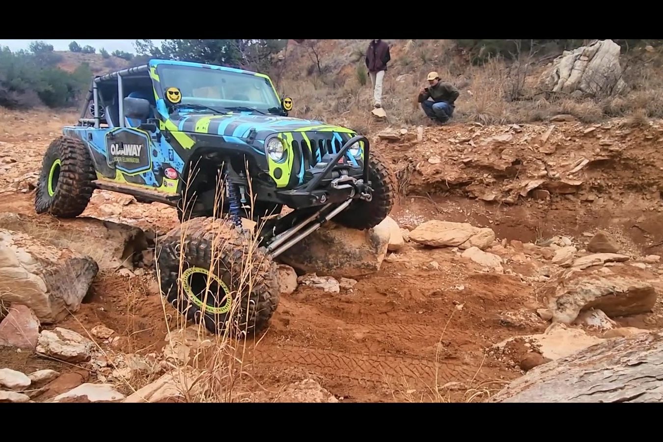 A Jeep crawling red rock out on the trail