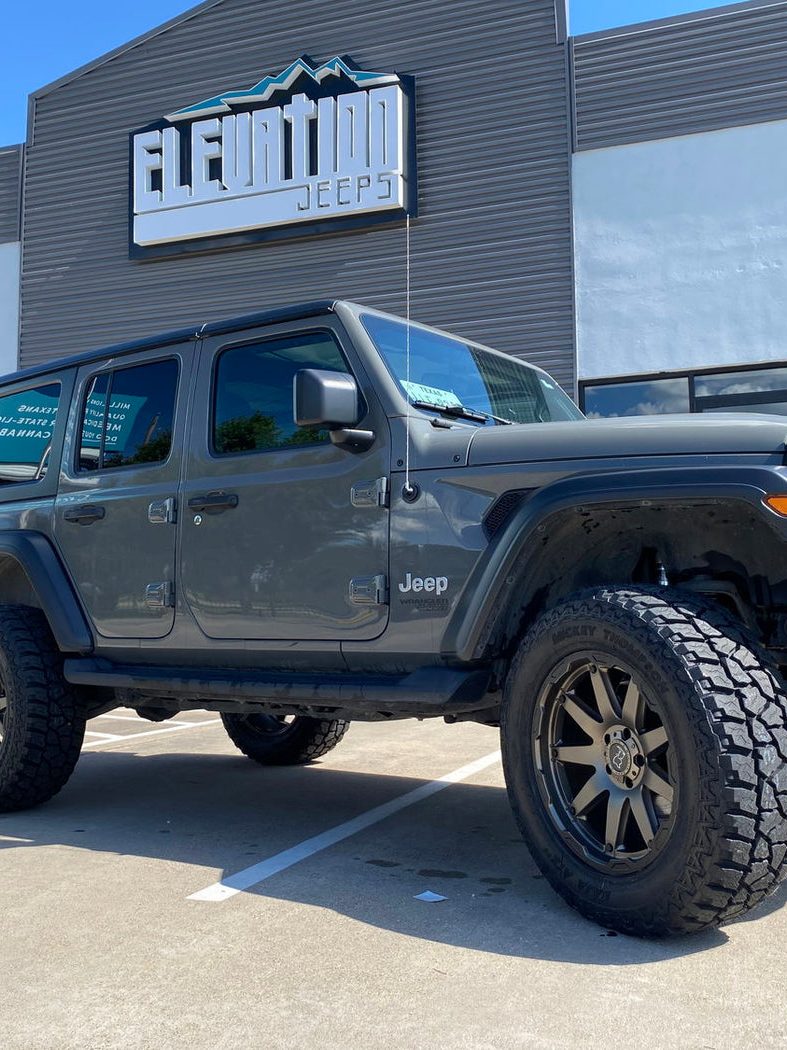 A lifted Jeep Wrangler build in front of the Elevation Jeeps shop