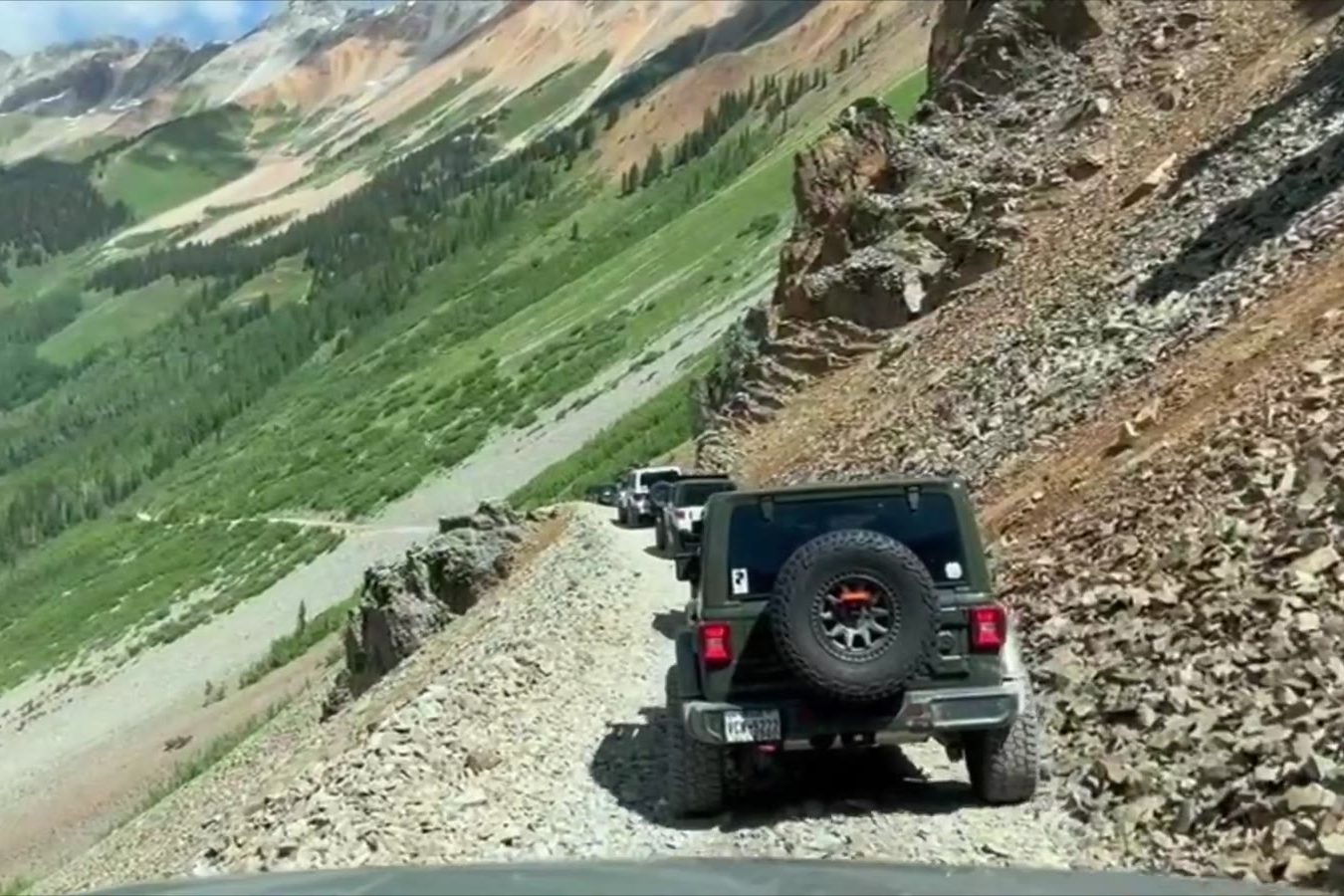 A rig descending a high mountain pass on an Elevation Nation trip