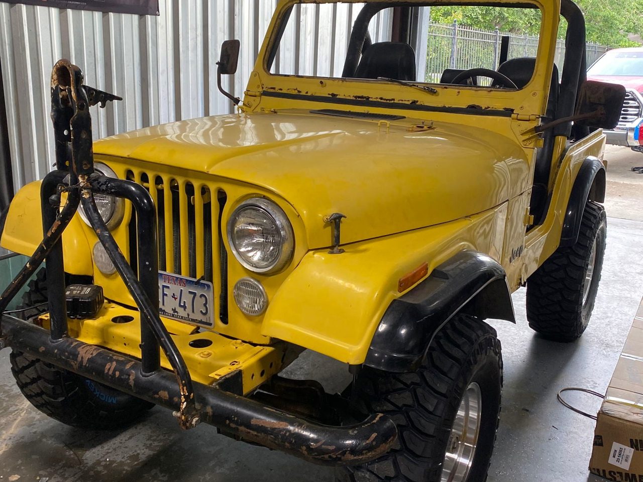 A classic yellow Jeep CJ build in the shop