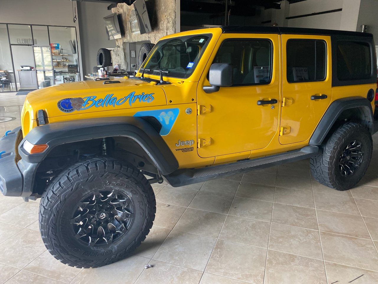 A yellow Jeep Wrangler Unlimited custom build