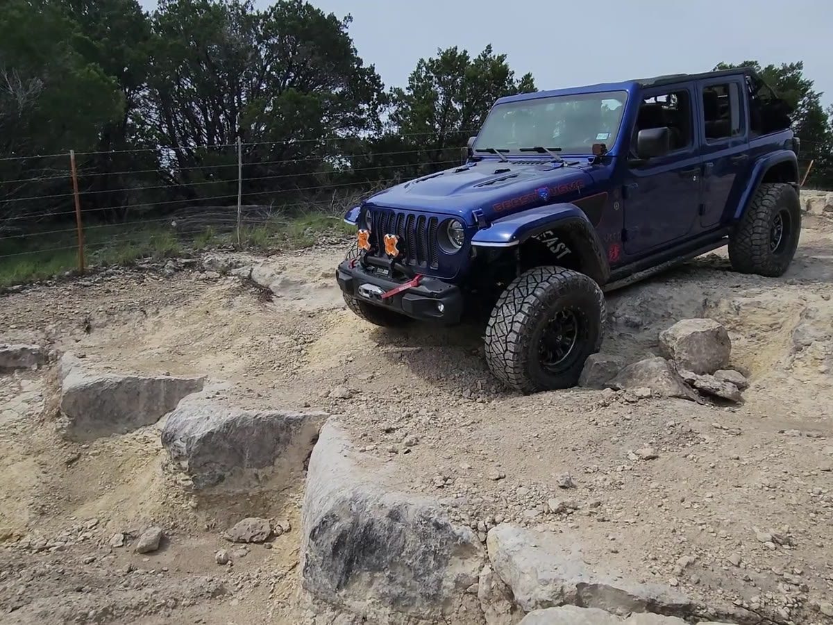 A Jeep crawling the rocks on a trail run