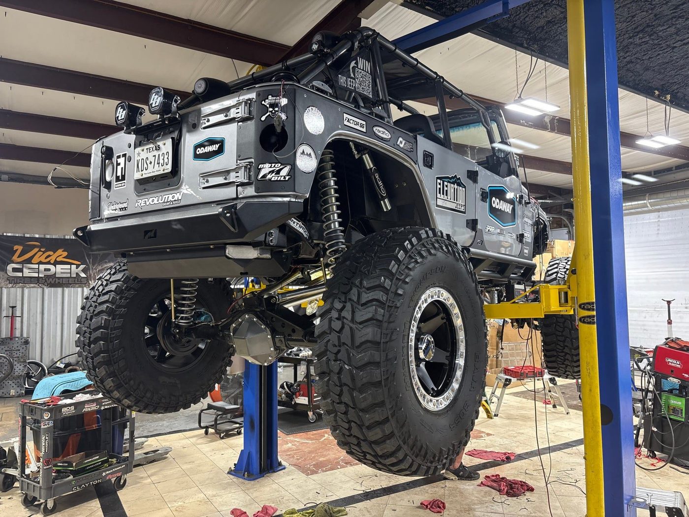 A Jeep up on the lift for a build in the shop