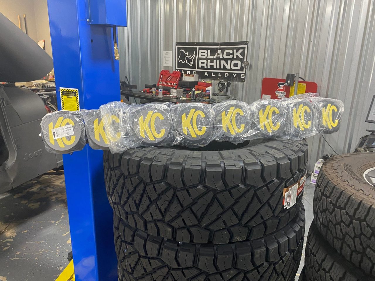 Wheels, tires, and parts staged in the shop